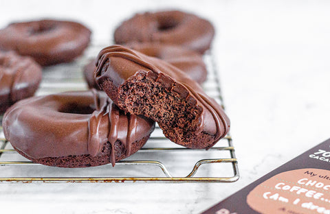 Chocolate vegan donuts against a white background.