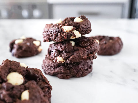 Stack of Chocolate cookies filled with vegan white and dark chocolate chips.