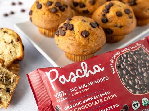 Pascha 100% chips in front of a white plate of chocolate chip muffins