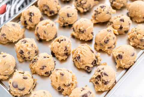 Baking tray full of chocolate chip cookie dough