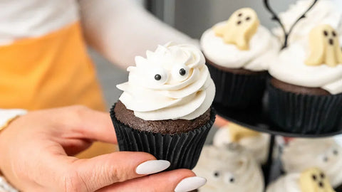 Halloween Chocolate Cream Filled Cupcakes decorated as mummies and ghosts with Pascha chocolate ganache, vegan white icing, and white chocolate ghosts.