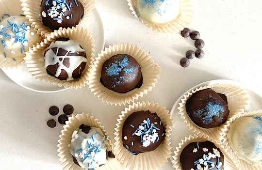 Hanukkah chocolates with white icing and blue sprinkles.