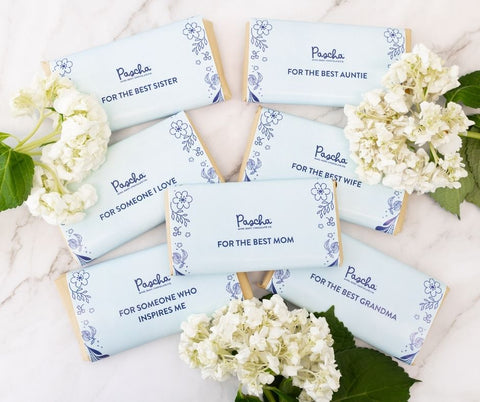 Pascha Chocolate Bars wrapped in beige wrapping paper and covered with a blue descriptive note with messages based on wishing a loved one a Happy Mother's Day