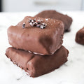 two square klondike bars stacked on top of one another sitting on a marble counter top