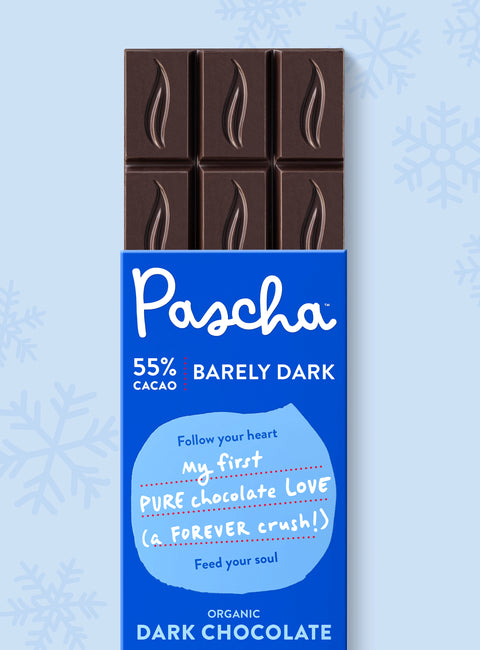 The front of Pascha Chocolate's 55% with Barely Dark Chocolate Bar with half of the exposed bar sticking out of the top of the packaging