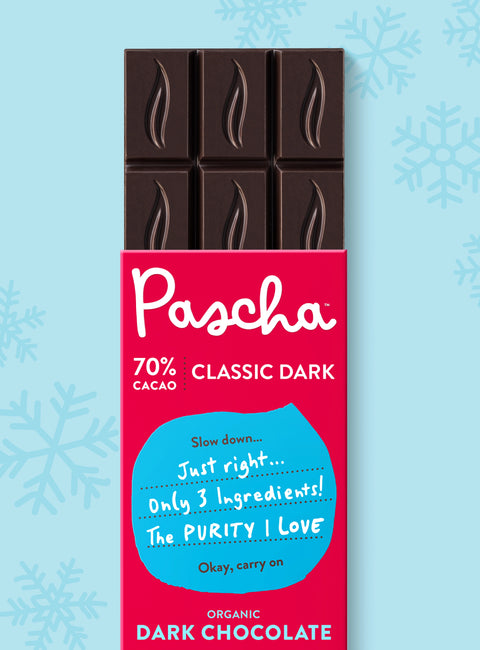 The front of Pascha Chocolate's 70% with Classic Dark Chocolate Bar with half of the exposed bar sticking out of the top of the packaging