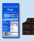 The back of Pascha chocolate's 55% cacao dark chocolate bar and bar of chocolate with bite taken out.