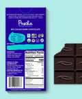 The back of Pascha chocolate's 85% cacao with dark chocolate bar and bar of chocolate with bite taken out.