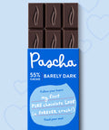 Pascha 55% Dark Chocolate Bar packaging with part of the chocolate bar coming out of the top on a blue background with hearts