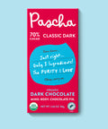 The front of Pascha Chocolate's 70% Classic Dark Chocolate Bar with half of the exposed bar sticking out of the top of the packaging