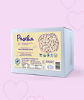 Pascha Organic Vegan White Chocolate Chips on a pink background with hearts