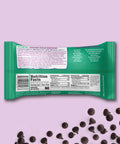 Pascha 70% Coconut chip bag with nutrition facts label on a light purple background with chocolate chips