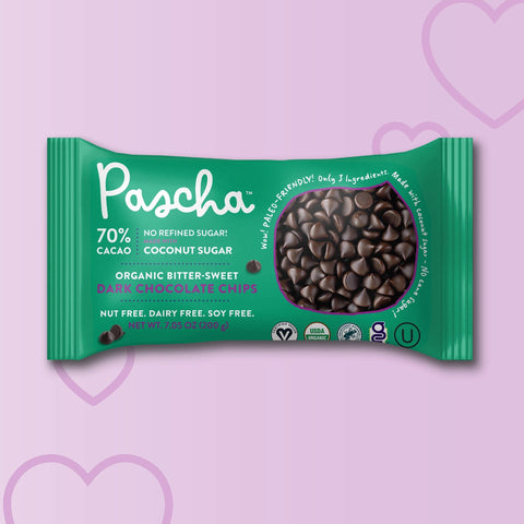 Green package of Pascha chocolate chips on a light purple background with heart shapes