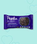 Pascha 85% Dark Chocolate Chips on a blue background with hearts