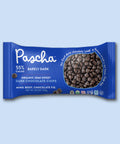 The front of the Pascha Chocolate 55% Barely Dark Organic Semi Sweet Baking Chips bag on a pink background