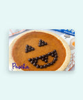 Pumpkin pie with chocolate chips shaped like a face on a Pascha card.